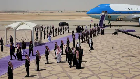 Getty Images Trump walking through a guard of honour with Saudi Crown Prince Mohammed bin Salman upon landing in Riyadh